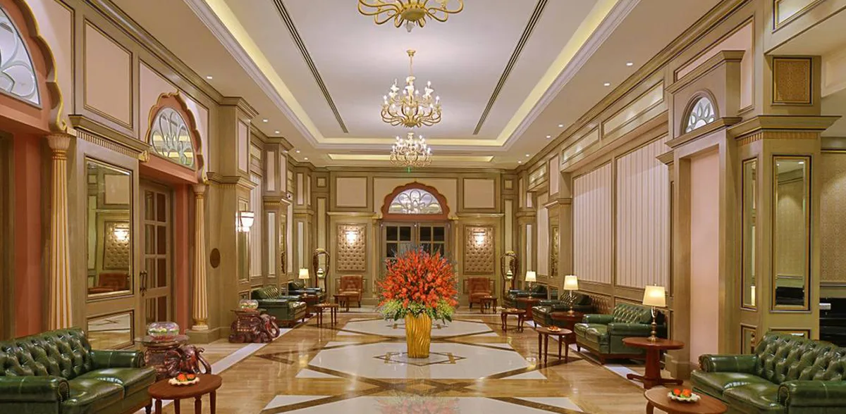 The opulent, chandelier-lit palace lobby at Indana Palace, Jaipur