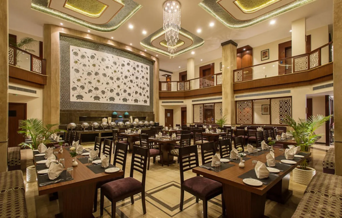 An elegant, chandelier-lit banquet interior at KK Royal Hotel, Jaipur