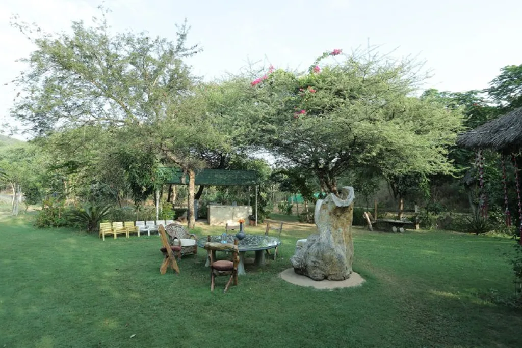 Lush green wedding lawns with rustic seating at Lohagarh Fort Resort, Jaipur
